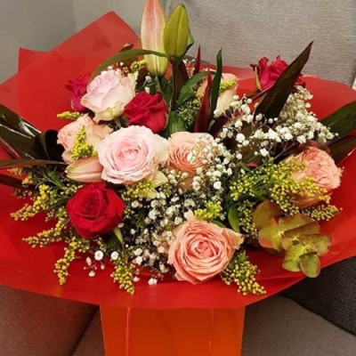 Love Actually - Seasonal flowers such as red roses, pretty pink roses, lilies and foliage.