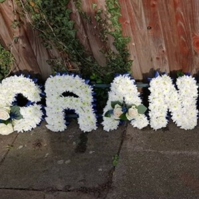 Gran lettering - Available in white basing chrysanthemum, with matching ribbon and spray