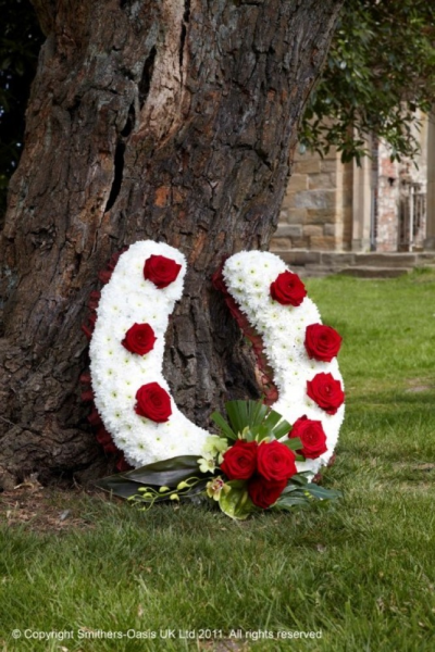 HORSE SHOE - Consisting of a double spray chrysanthemum base with red rose spray.