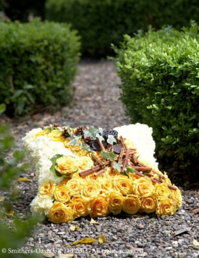 YELLOW AND WHITE CUSHION - A rose based cushion in white and orange.