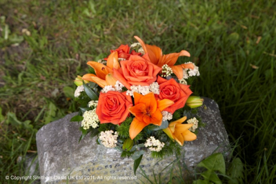 ORANGE POSY - A classic posy of orange shades and foliage.