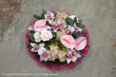 PINK LACE POSY - A modern pink posy including orchids and roses.